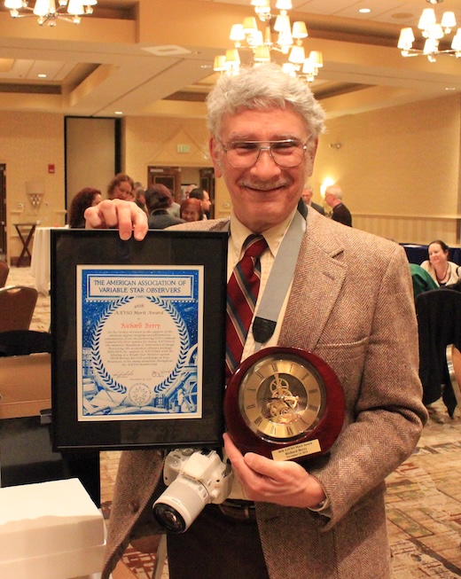 "Richard Berry holding his Merit Award, in a hotel ballroom"